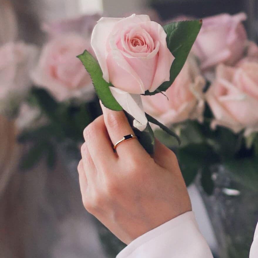 black-zircon-ring-woman-holds-a-soft-pink-rose.jpg